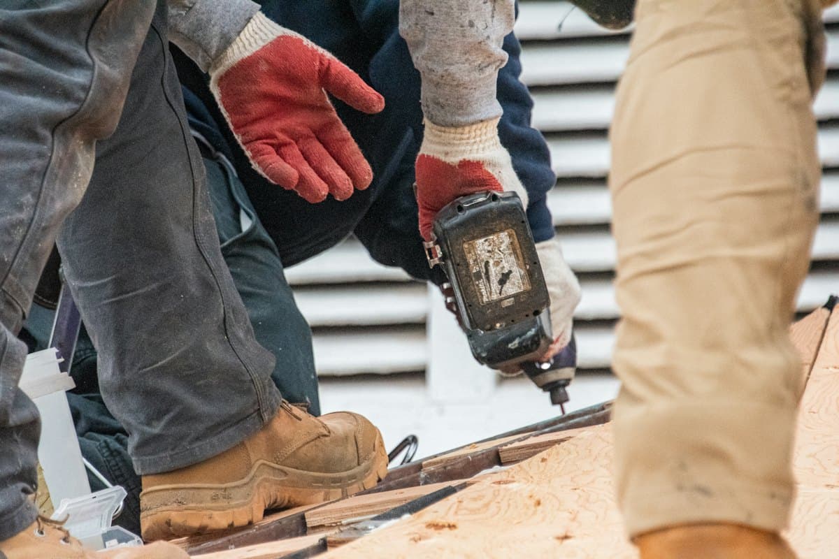 Crew fastening roof sheathing